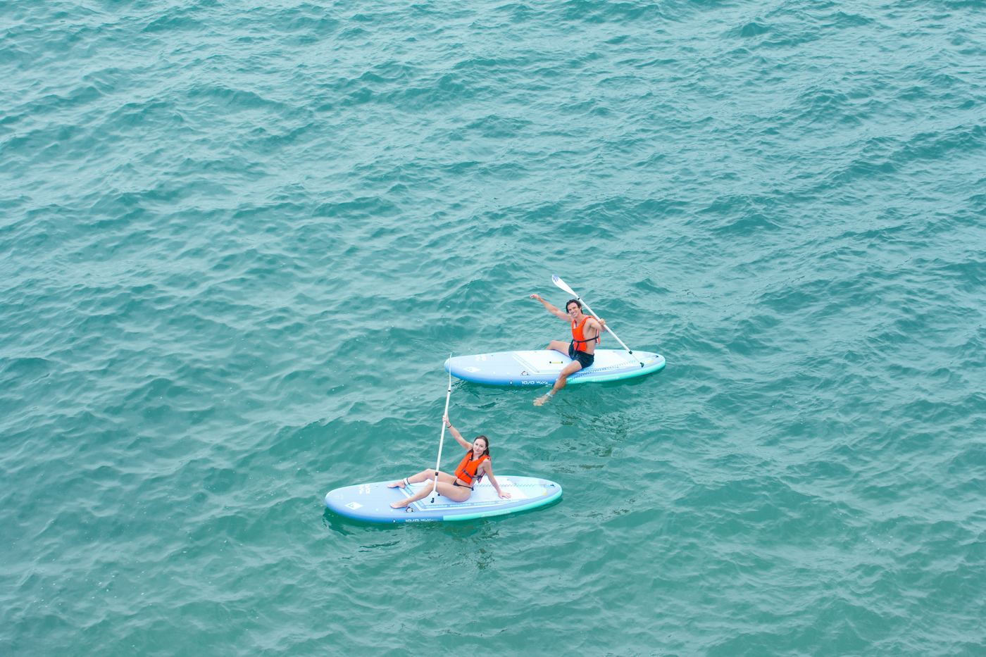 Two guests relaxing on SUP boards